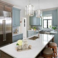 Gray painted kitchen cabinets with stained wood cabinets in a vintage inspired kitchen