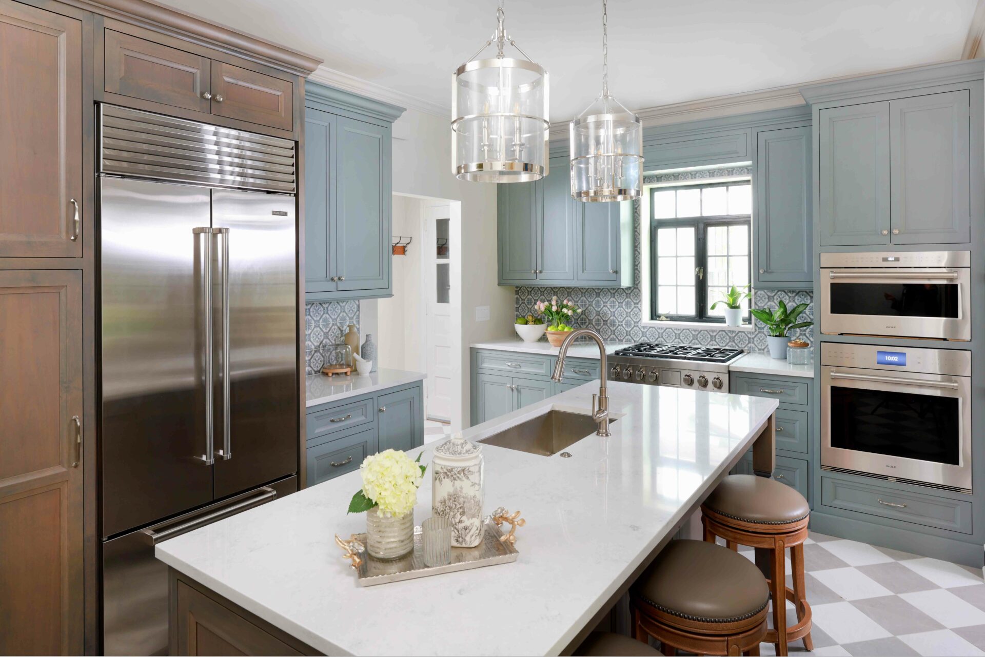 Gray painted kitchen cabinets with stained wood cabinets in a vintage inspired kitchen