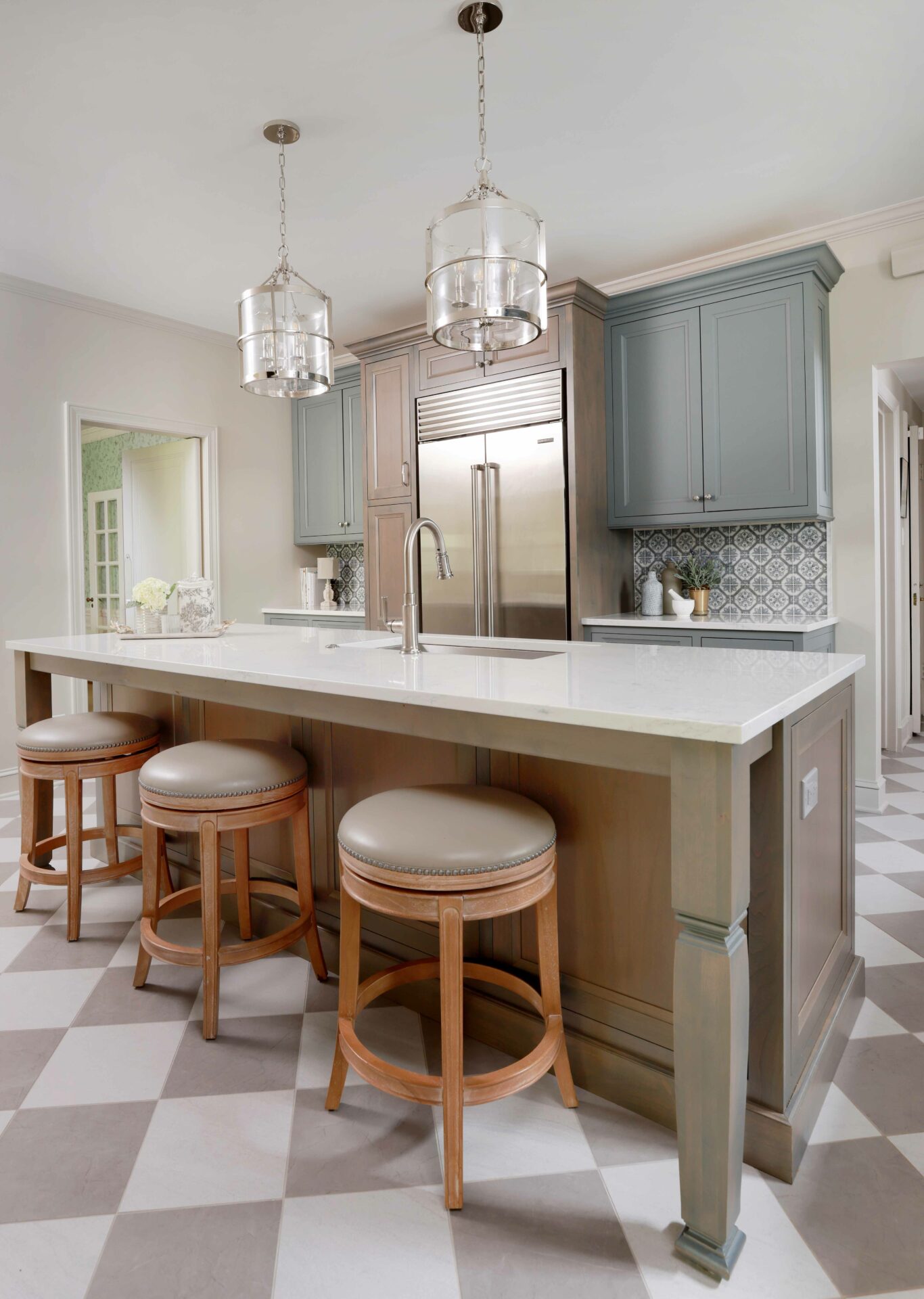 Kitchen island with stained cabinetry and perimeter kitchen cabinets painted gray