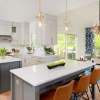 White kitchen with double islands and adjacent dining space