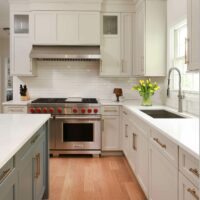 Warm white and gray kitchen cabinets with stainless steel appliances