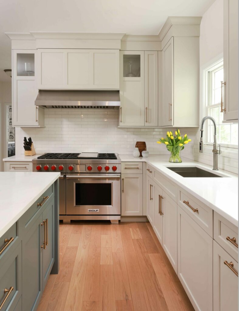 Warm white and gray kitchen cabinets with stainless steel appliances