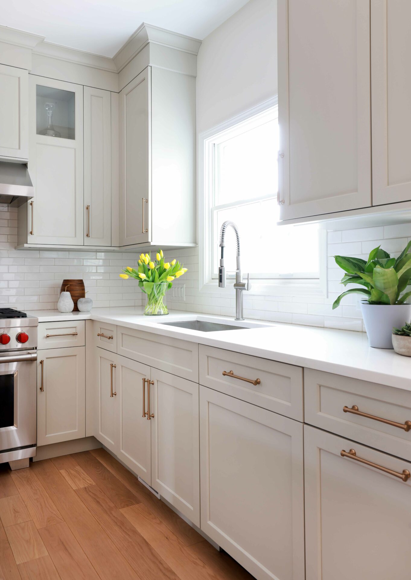 Warm white kitchen cabinets with undermount sink