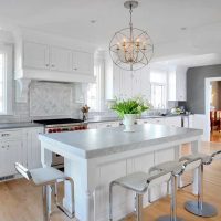 all white kitchen with island featuring quartz countertop