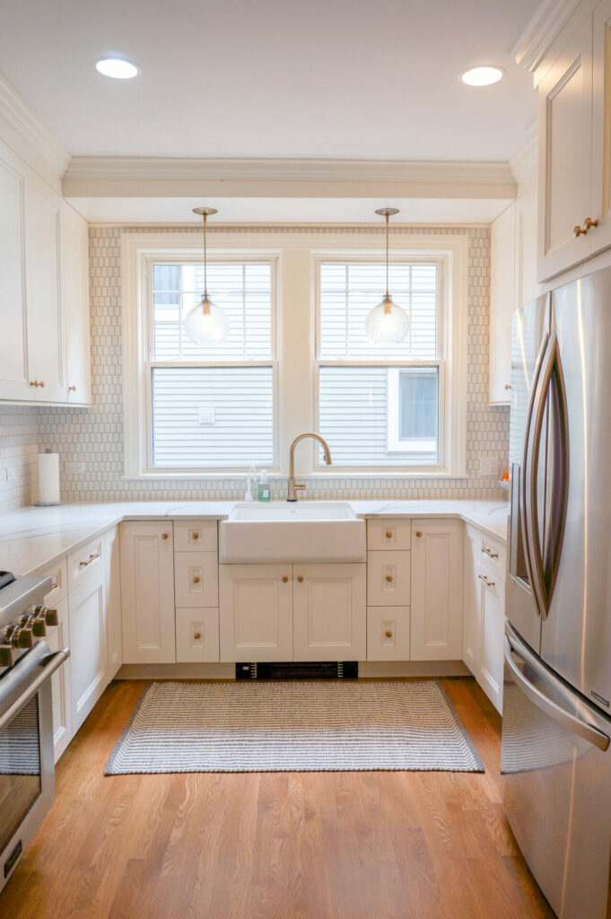 white kitchen with apron front sink and mini soffit above windows