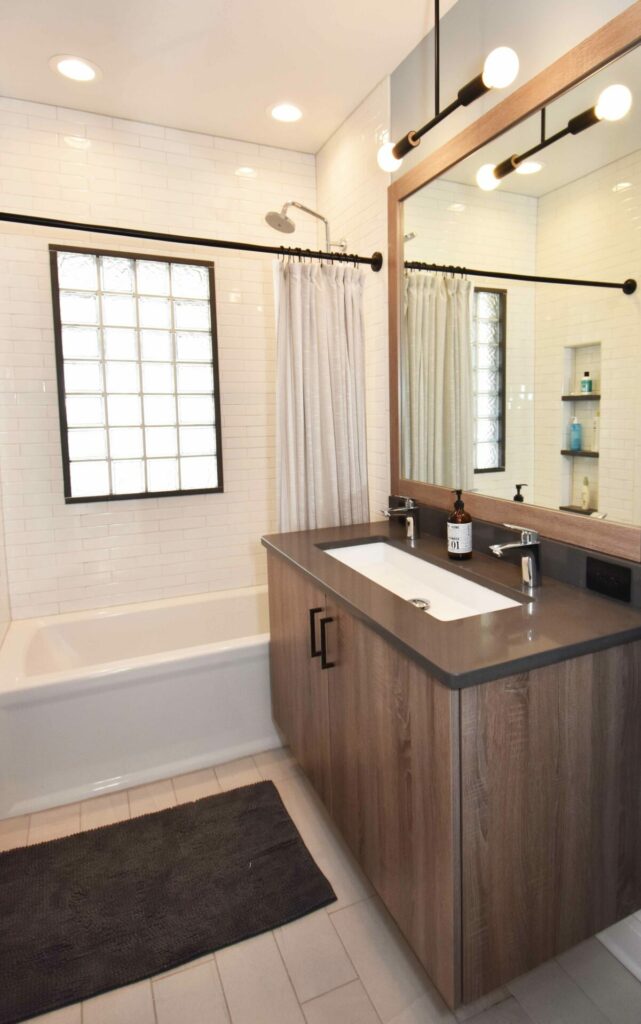 full bathroom with shower curtain and floating vanity