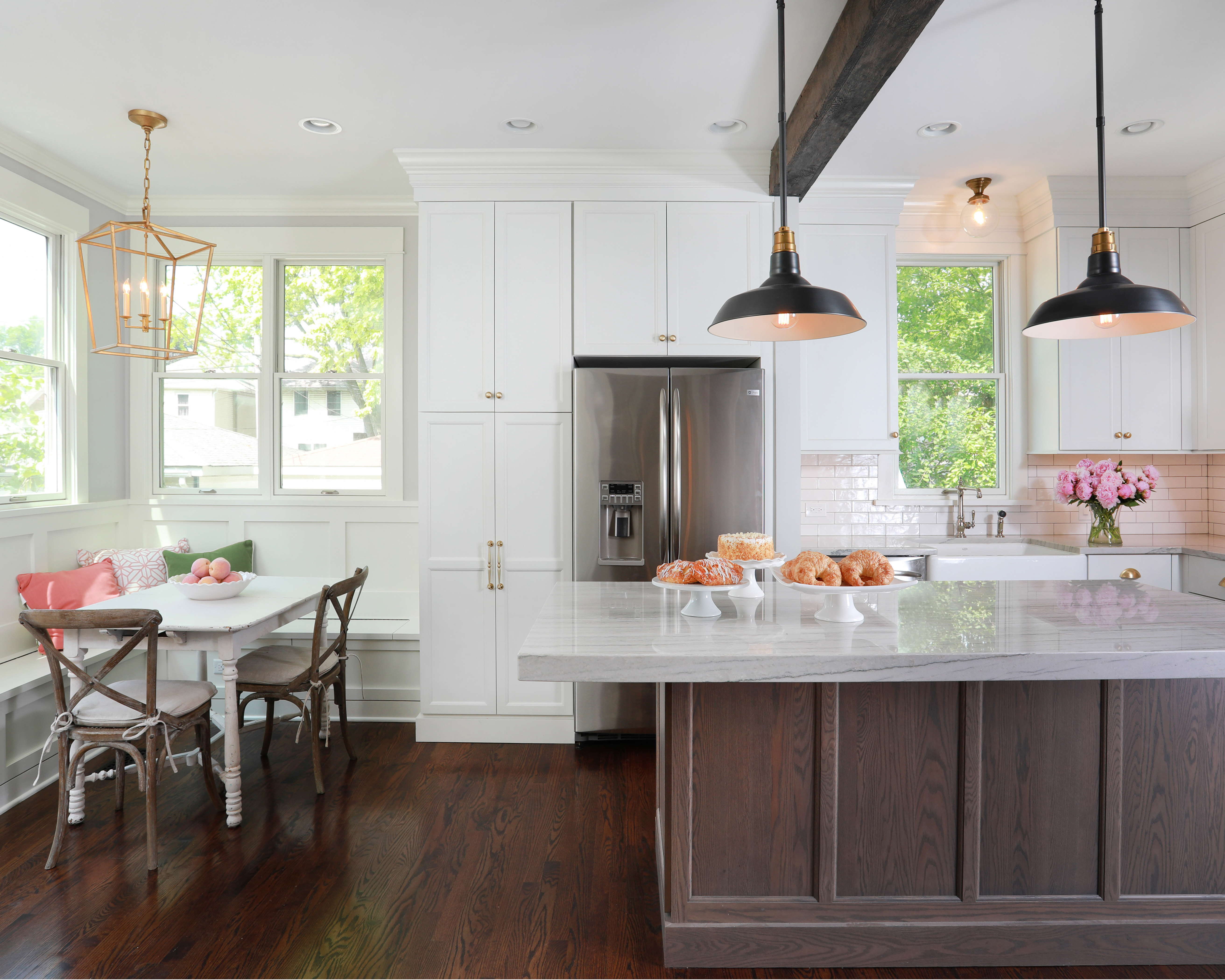 White kitchen cabinets with distressed wood island cabinet and reclaimed wood beams