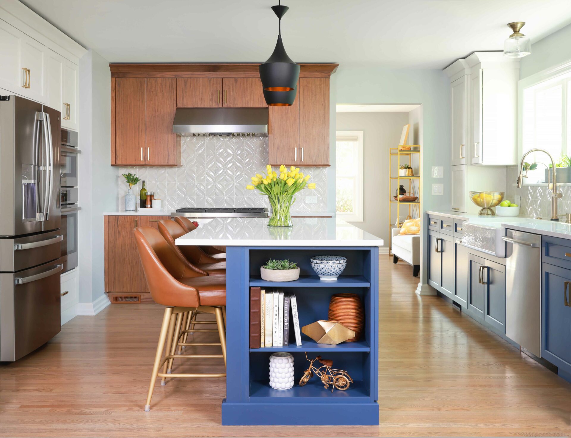 U shaped kitchen with island featuring walnut cabinets, white painted cabinets, and blue painted kitchen cabinets