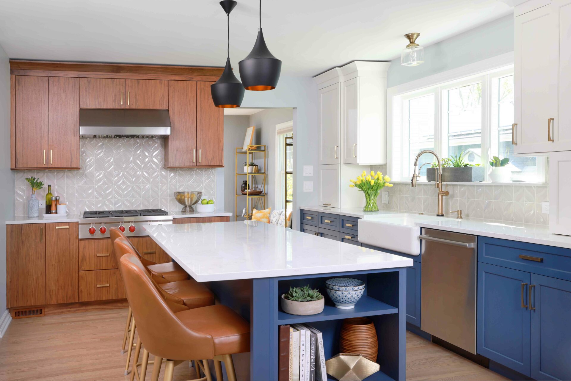Three color kitchen cabinets are walnut, white and blue, with blue island