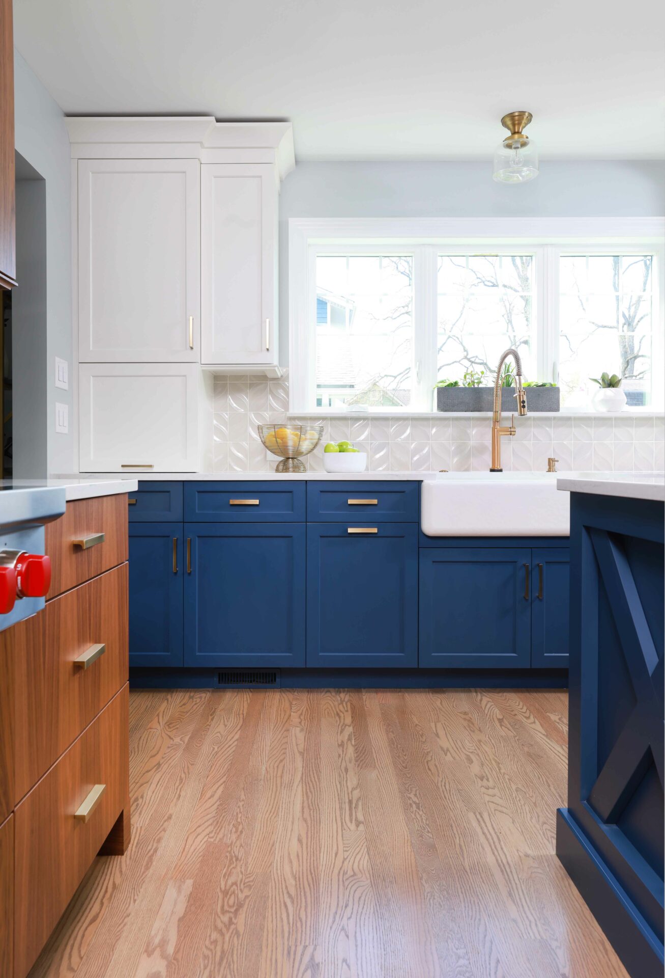 Tri-tone kitchen with walnut cabinets, blue cabinets, and white cabinets