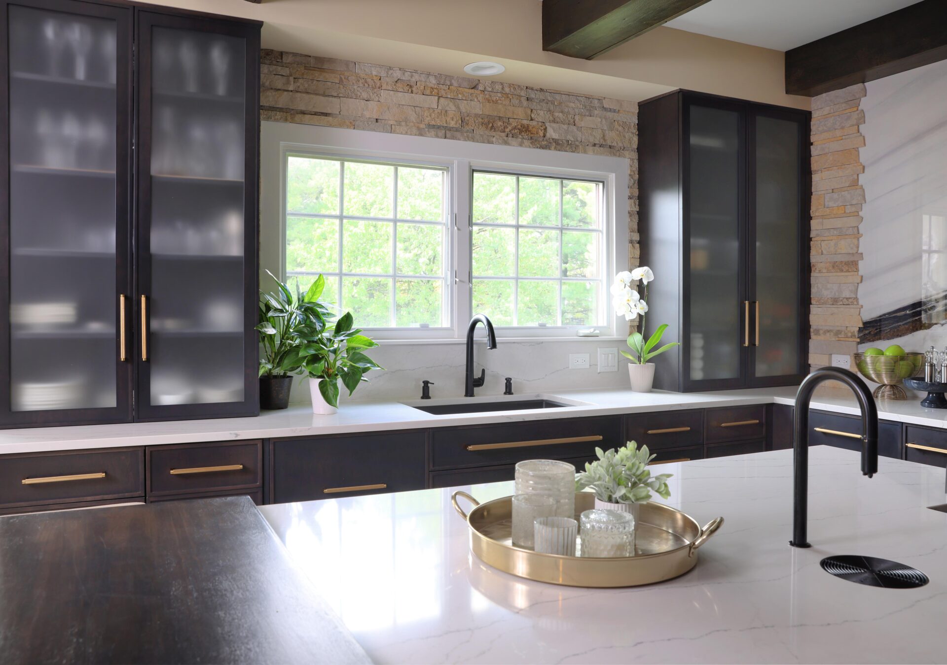 black stained kitchen with glass front cabinets