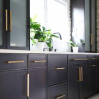 black stained kitchen cabinets with gold hardware