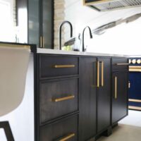 black stained kitchen cabinets with gold accents