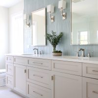 Primary bathroom with warm gray cabinets and blue tile