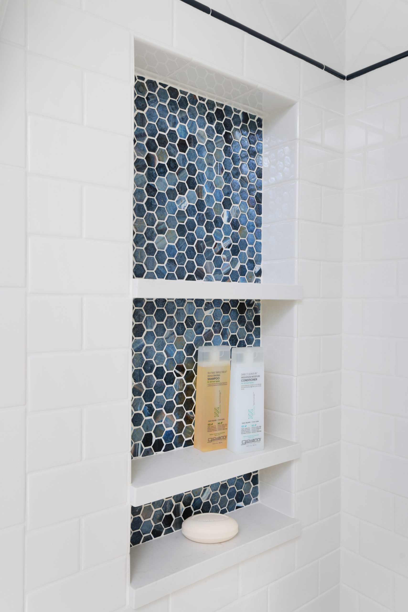 Decorative shower niche with blue hex tile