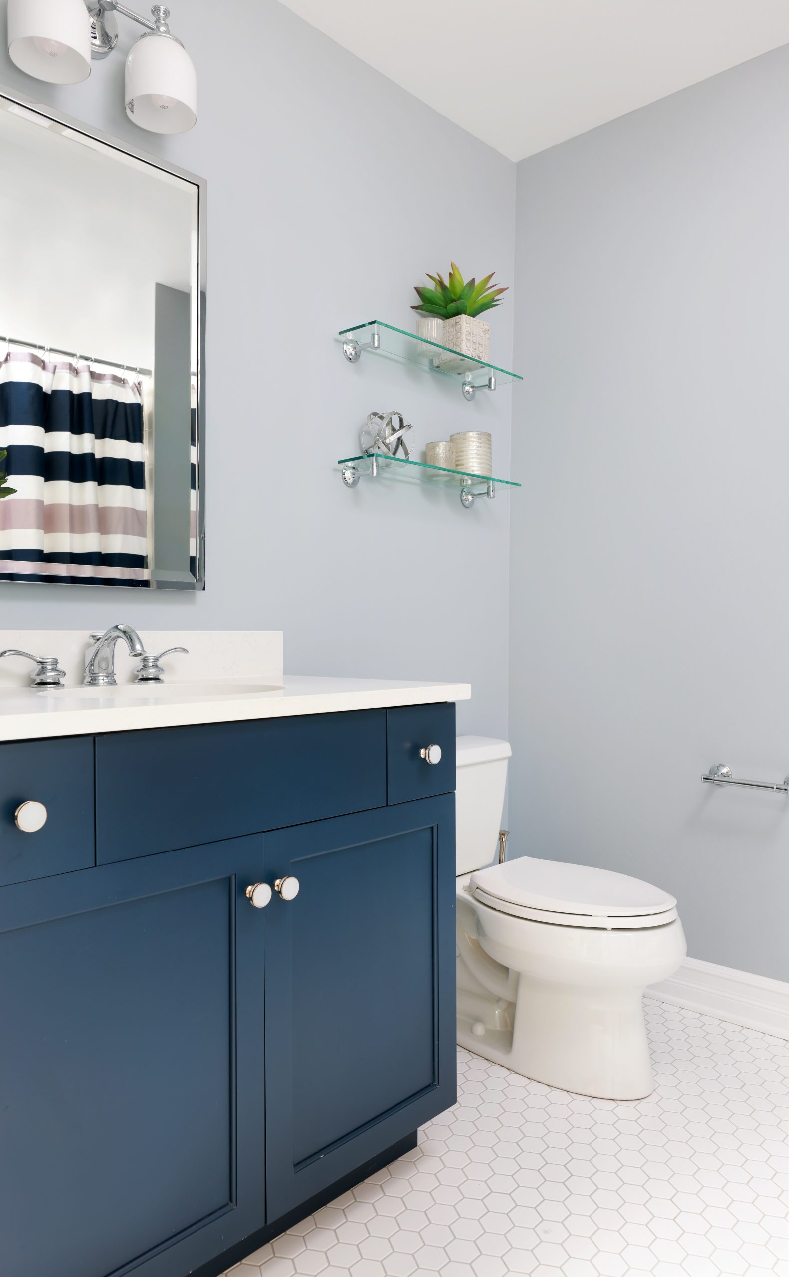 Kids hall bathroom with blue cabinet