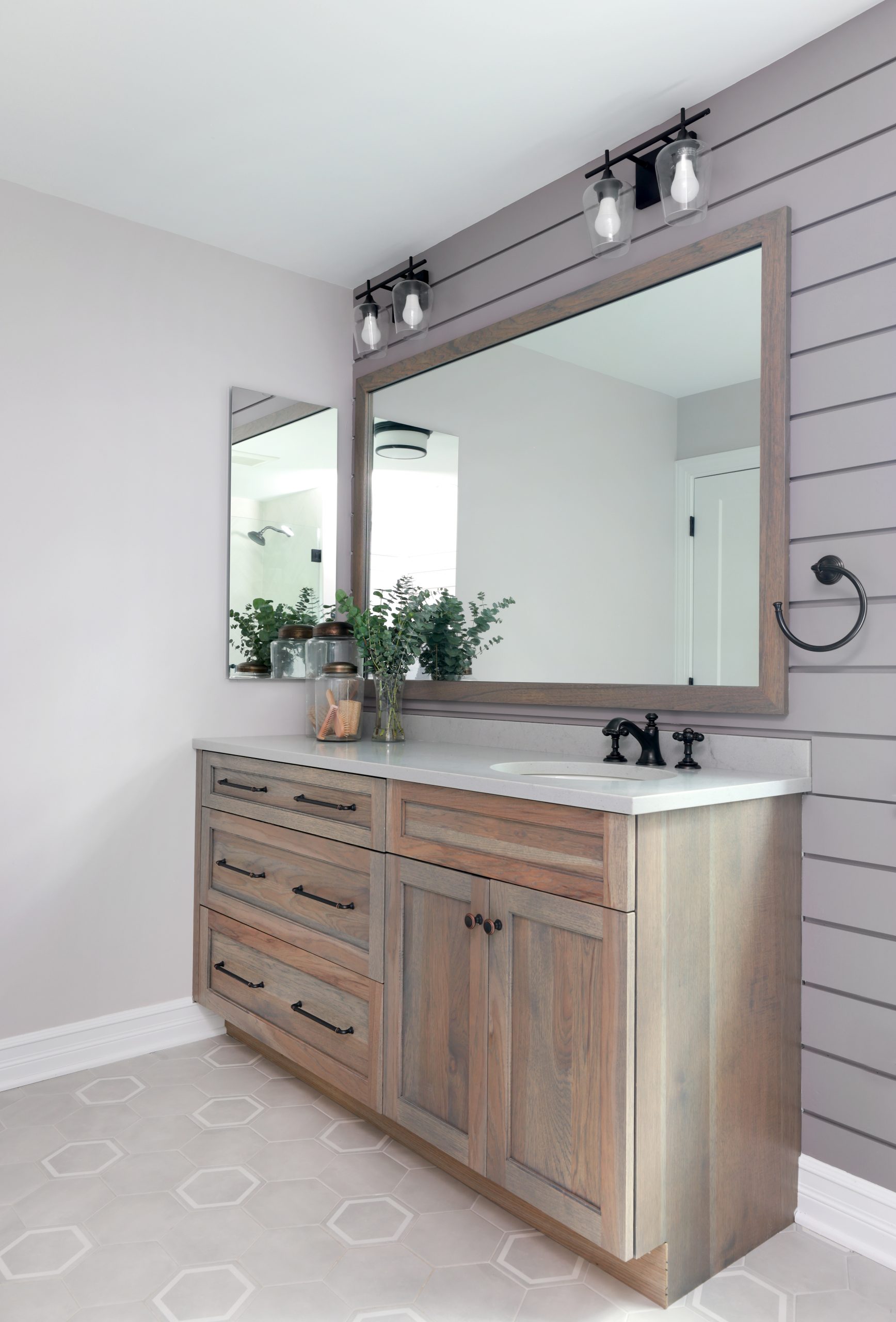 Hickory vanity and shiplap walls in a hall bathroom