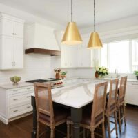 White kitchen cabinets with dark island