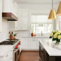 white kitchen with stained wood trim hood