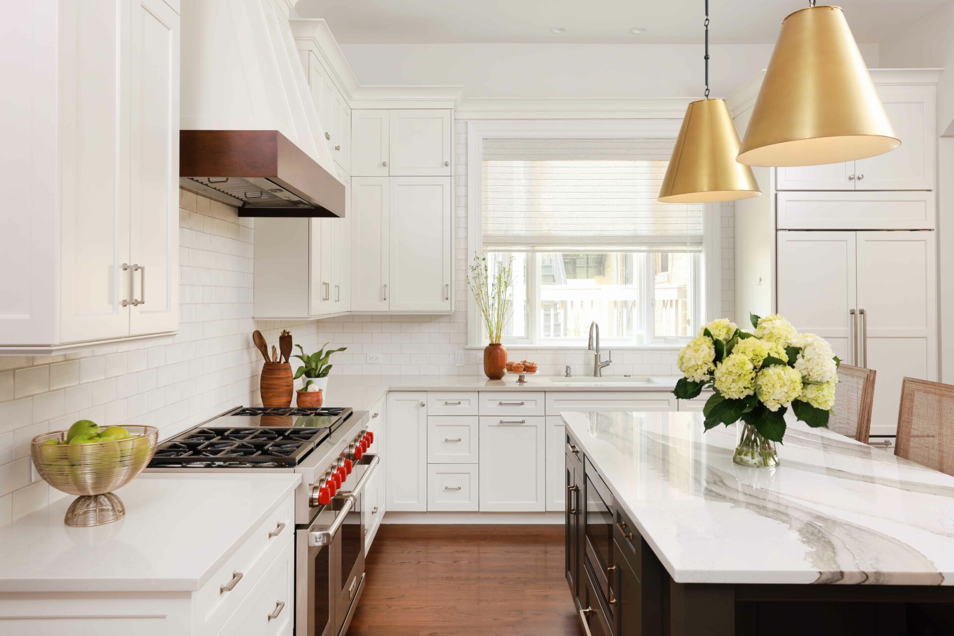 white kitchen with stained wood trim hood