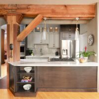 Chicago condo two-tone kitchen with exposed wooden beam incorporated into island