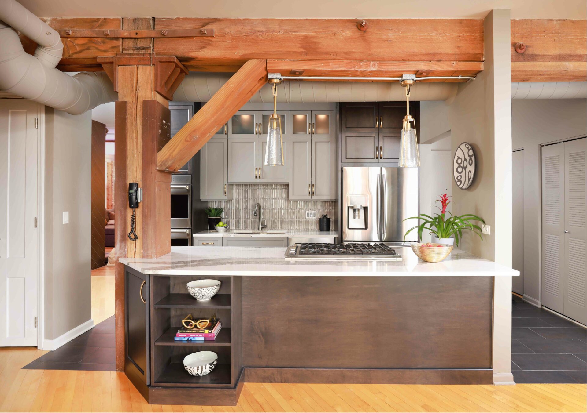 Chicago condo two-tone kitchen with exposed wooden beam incorporated into island
