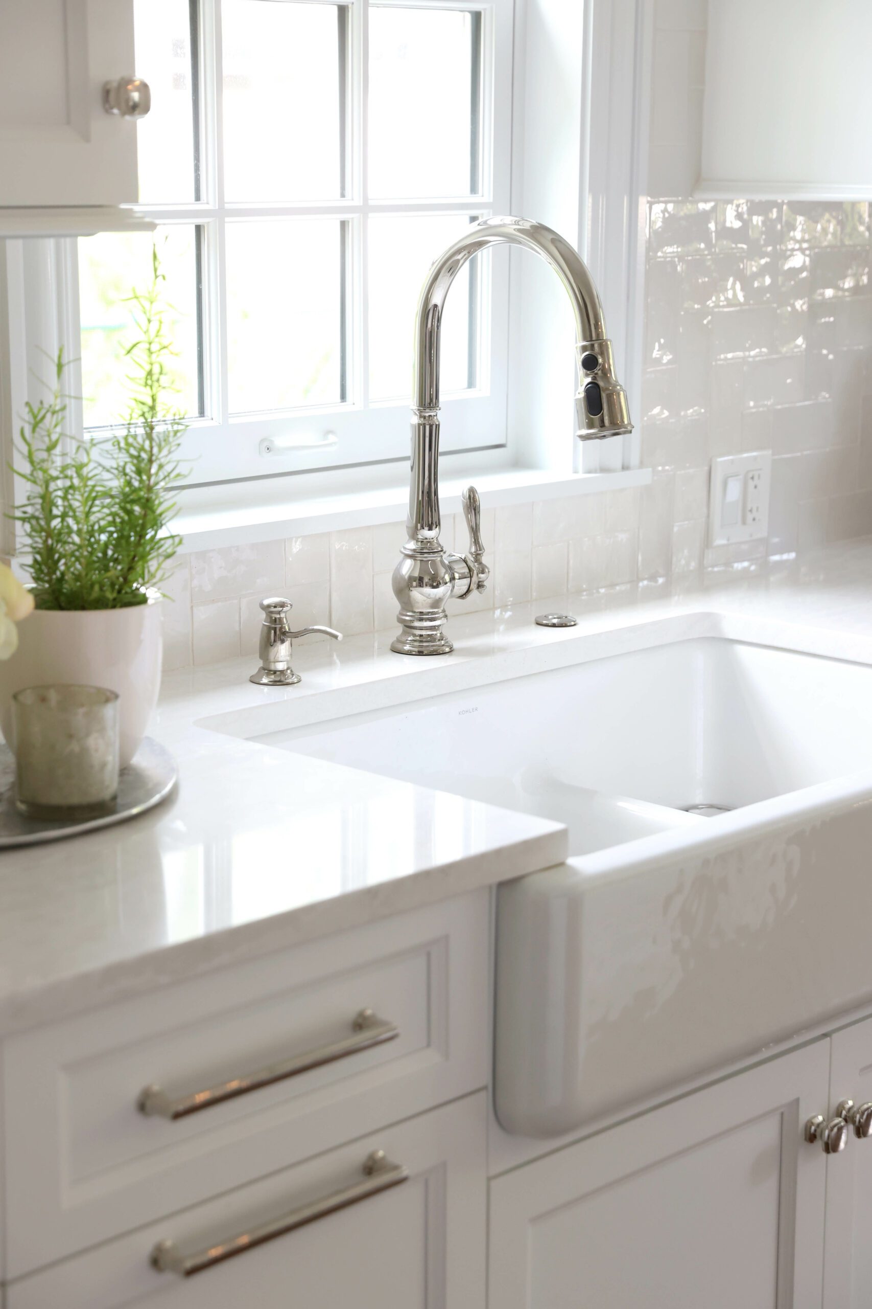 apron front kitchen sink and textured white backsplash