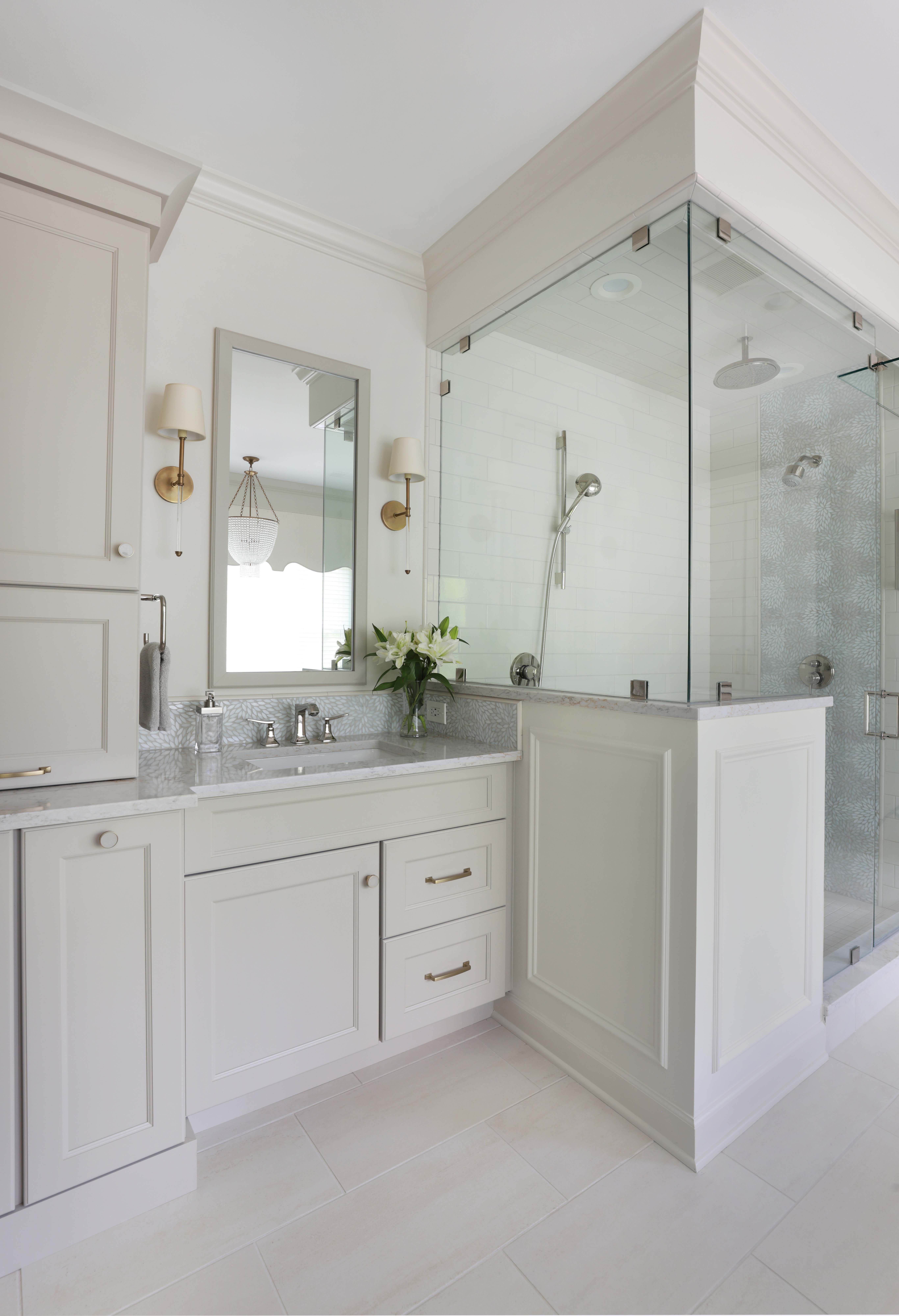 traditional bathroom in light gray with separate vanities and separate bathtub and shower