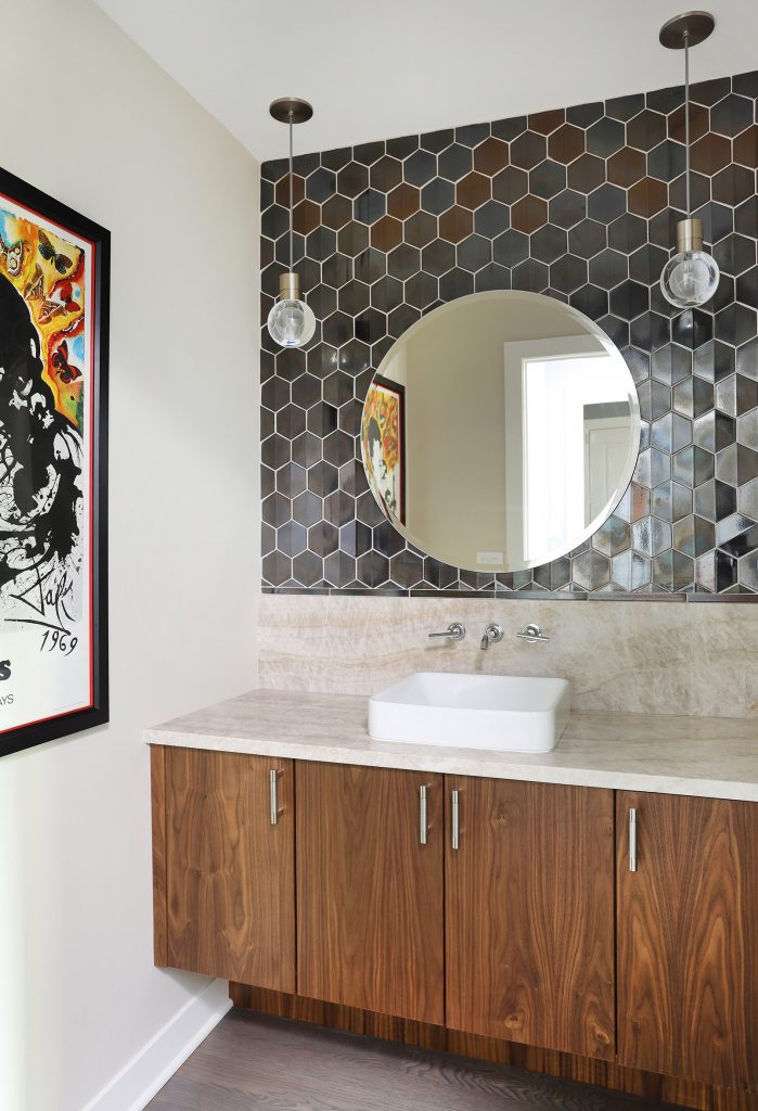powder room with floating vanity and mirrored hexagon backsplash