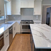 White shaker style kitchen with dark stained island