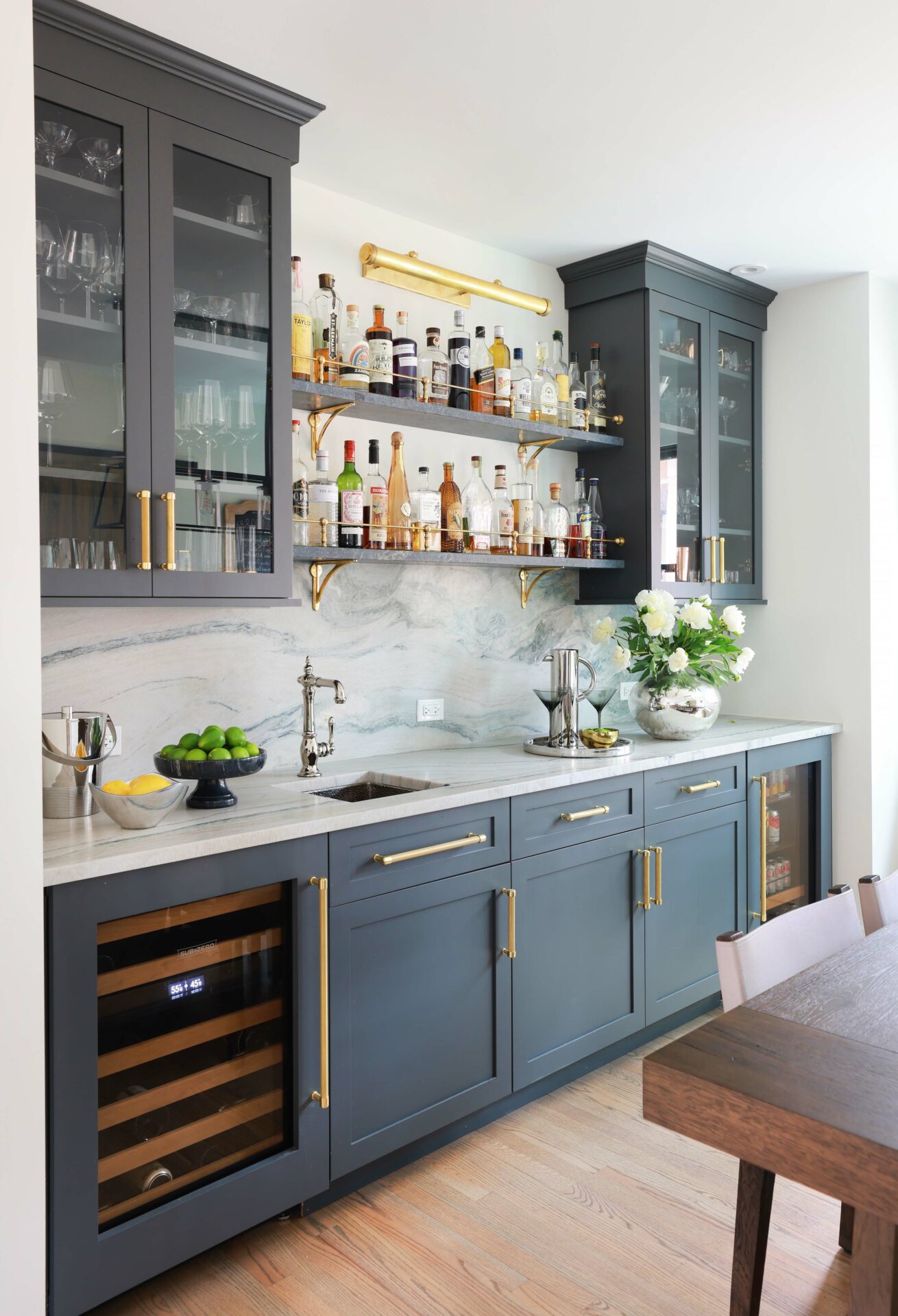 Wet bar with open shelving and painted cabinetry