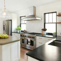 L shaped white kitchen with peninsula and island