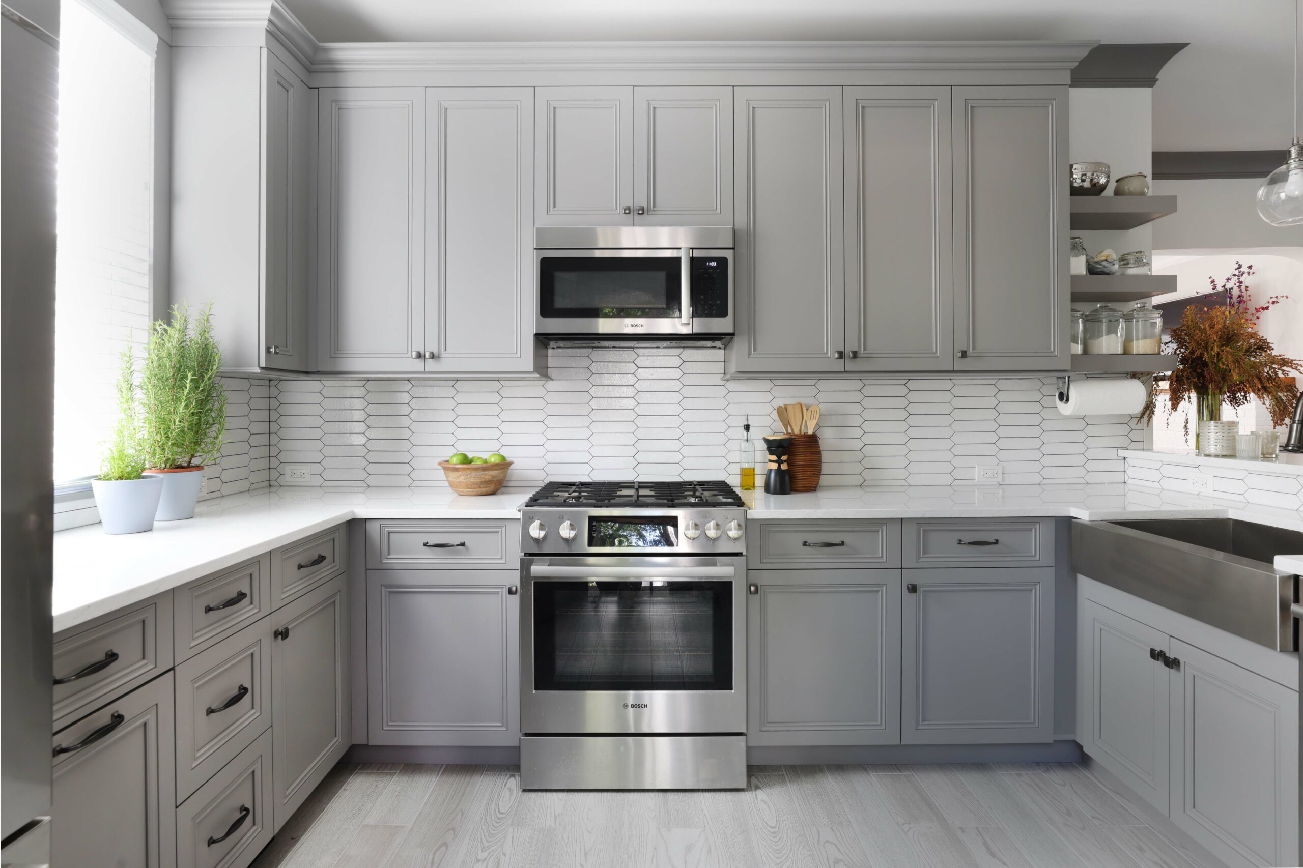 gray kitchen with stainless steel sink and appliances and ceramic backsplash