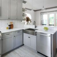 gray kitchen with stainless steel sink and dishwasher