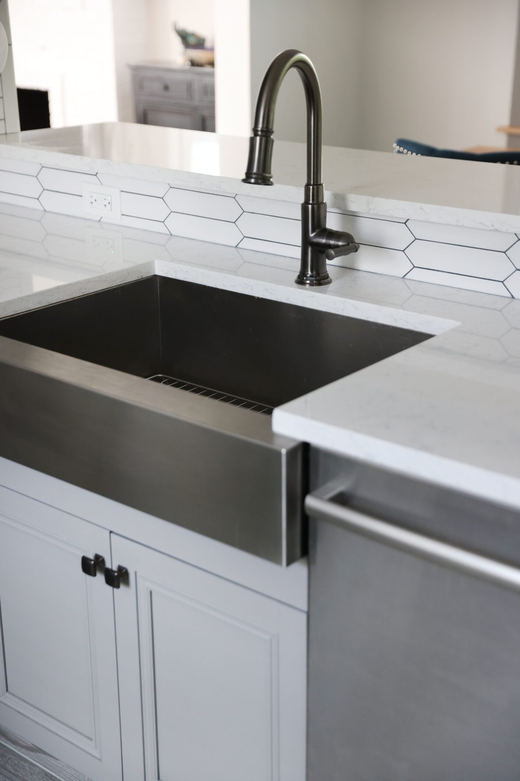 stainless steel apron front sink in gray kitchen