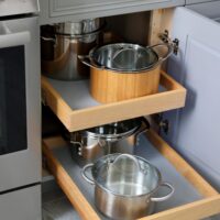 pull out shelves for pots and pans in gray kitchen