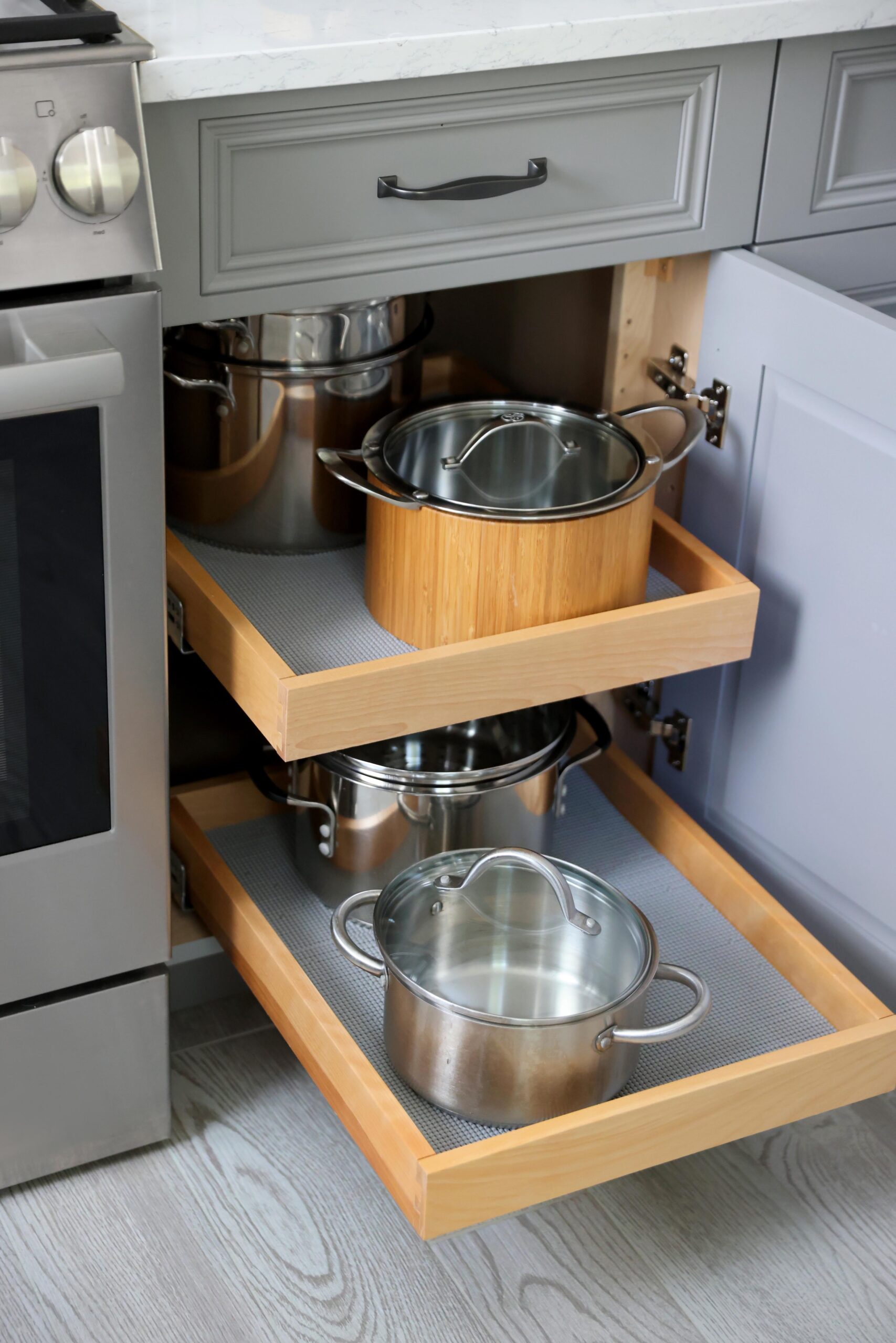 pull out shelves for pots and pans in gray kitchen