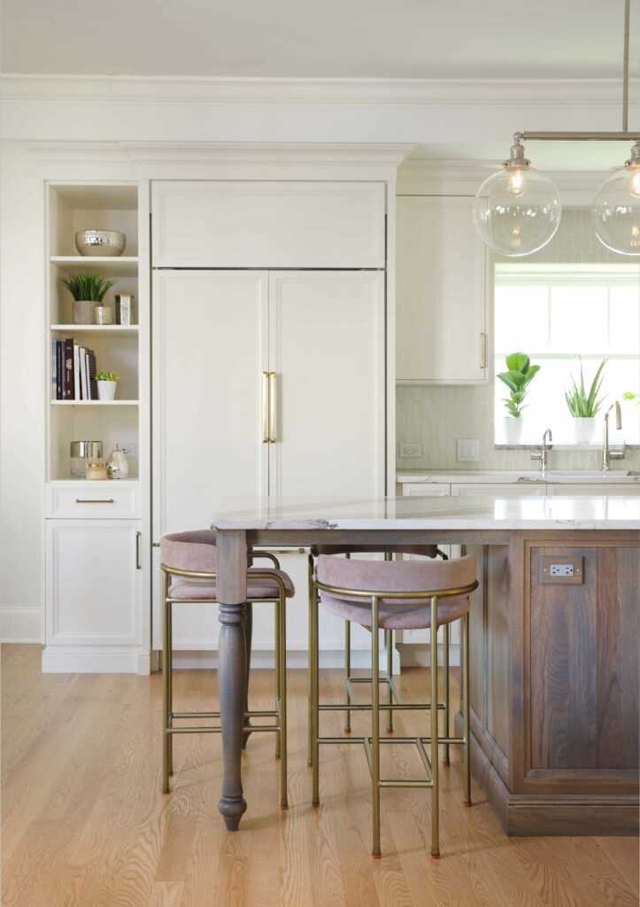 paneled fridge and hickory island in white kitchen
