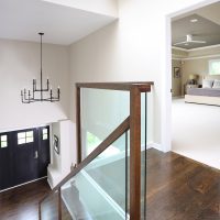 modern glass and wood staircase overlooking foyer