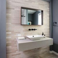 Powder room with accent tile, floating vanity and vessel sink