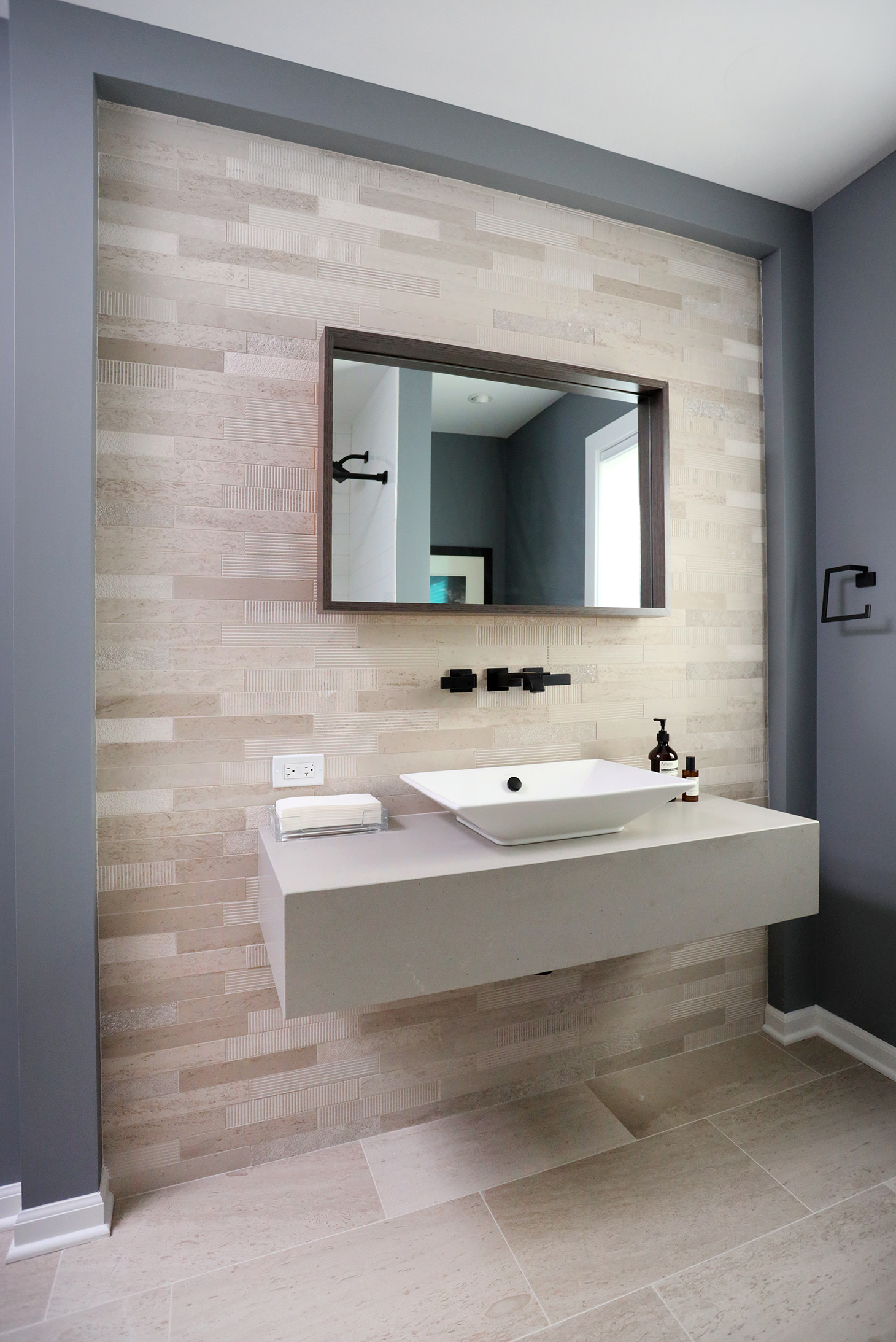 Powder room with accent tile, floating vanity and vessel sink