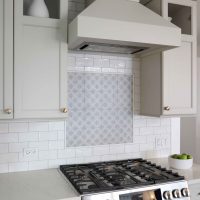 backsplash to the ceiling, small painted hood range and special tile niche over range, upper cabinets with partially open front doors