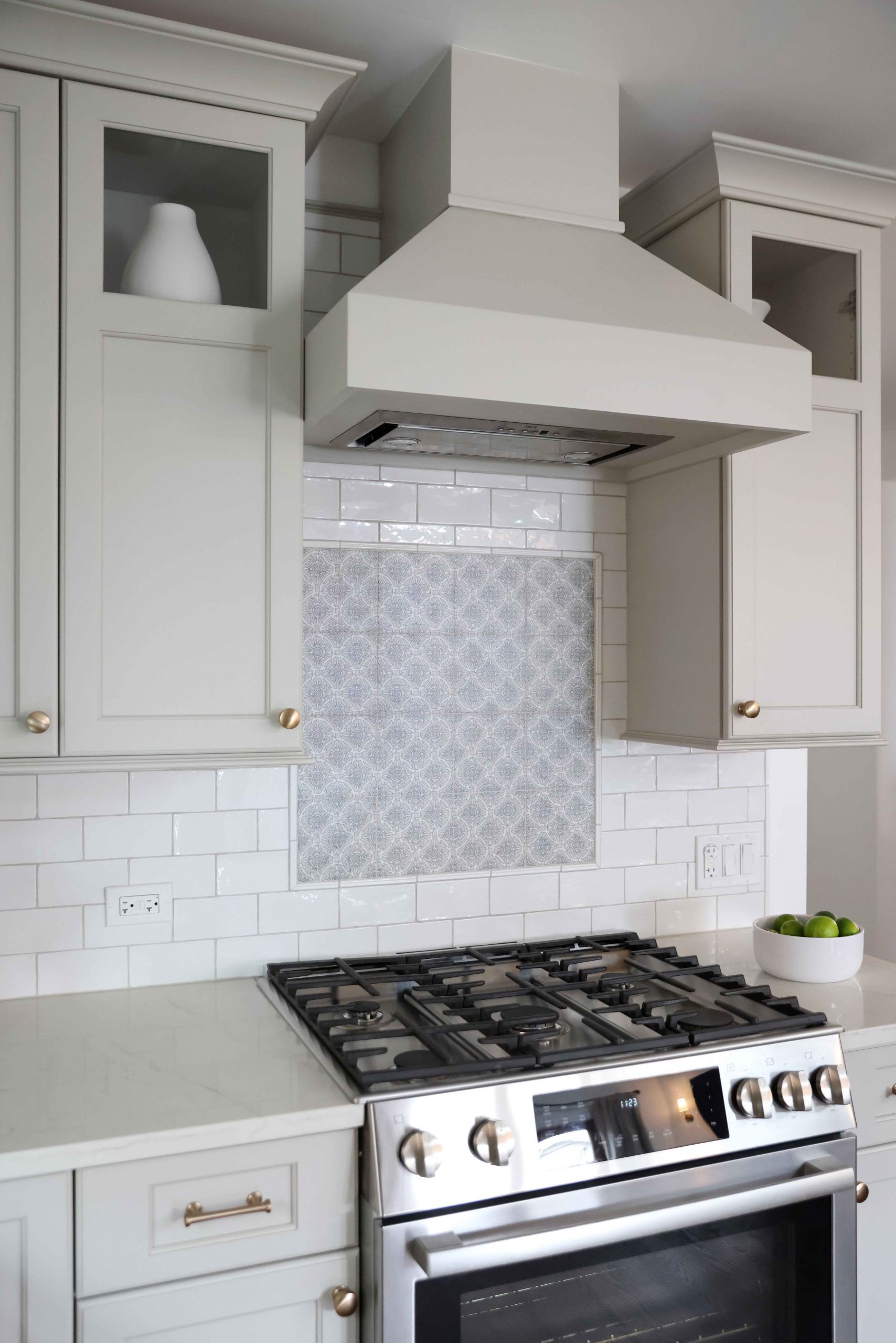 backsplash to the ceiling, small painted hood range and special tile niche over range, upper cabinets with partially open front doors
