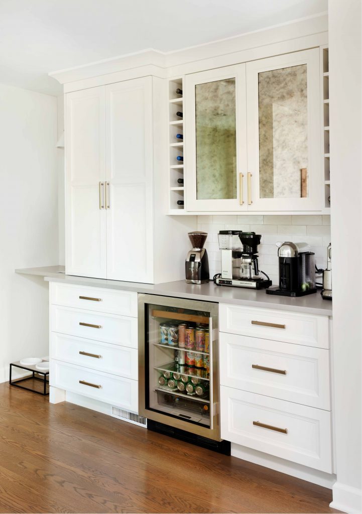 white kitchen coffee bar with beverage center and glass front cabinetry
