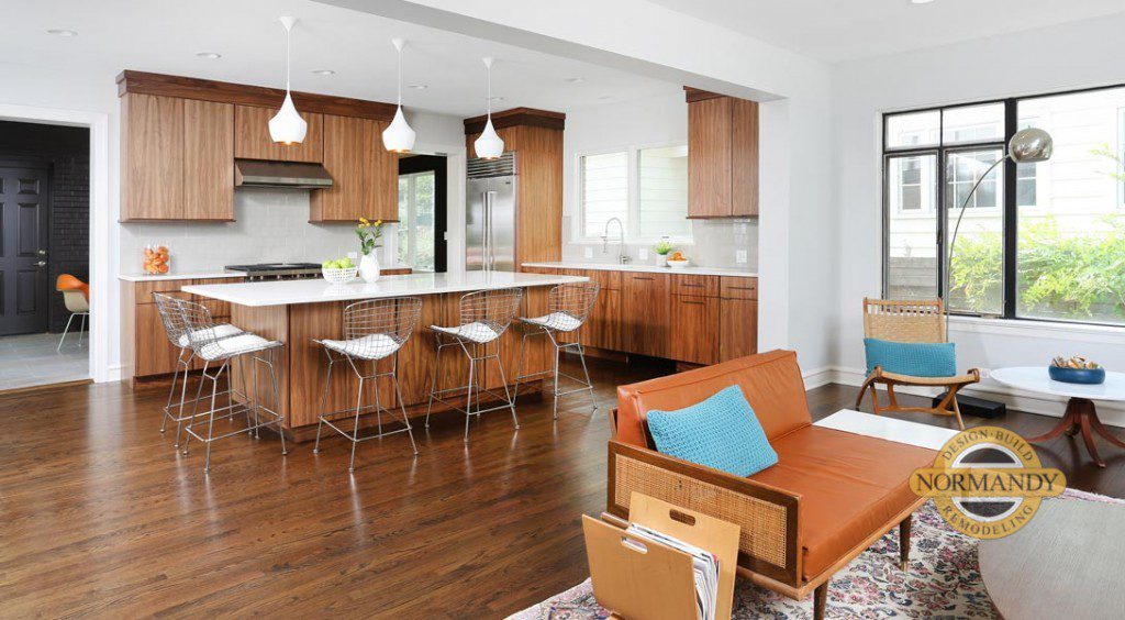 open floorplan Mid-Century modern kitchen with stained cabinetry in medium wood tones