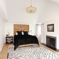 primary bedroom with fireplace and hardwood floors