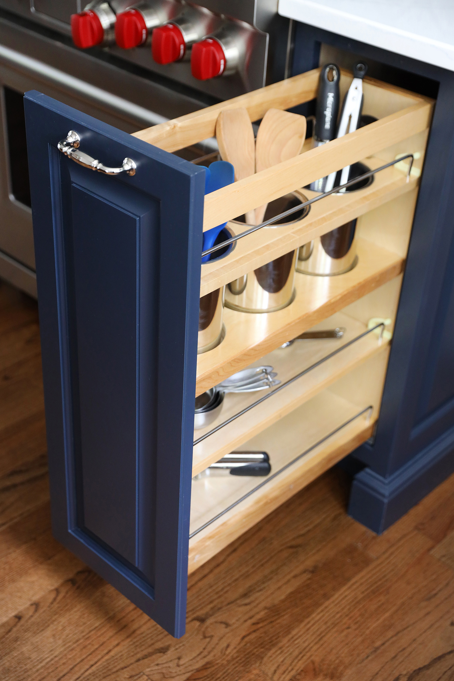 Blue kitchen cabinets with pull out organizer
