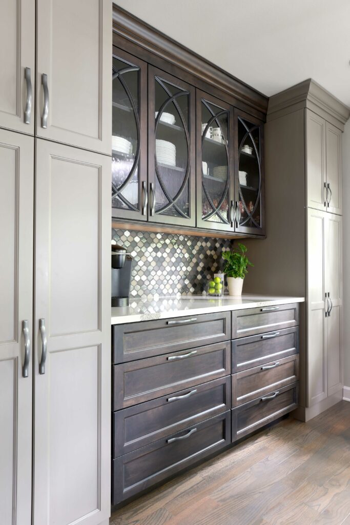 Built in hutch with gray painted and dark stained cabinetry, mullion cabinet doors